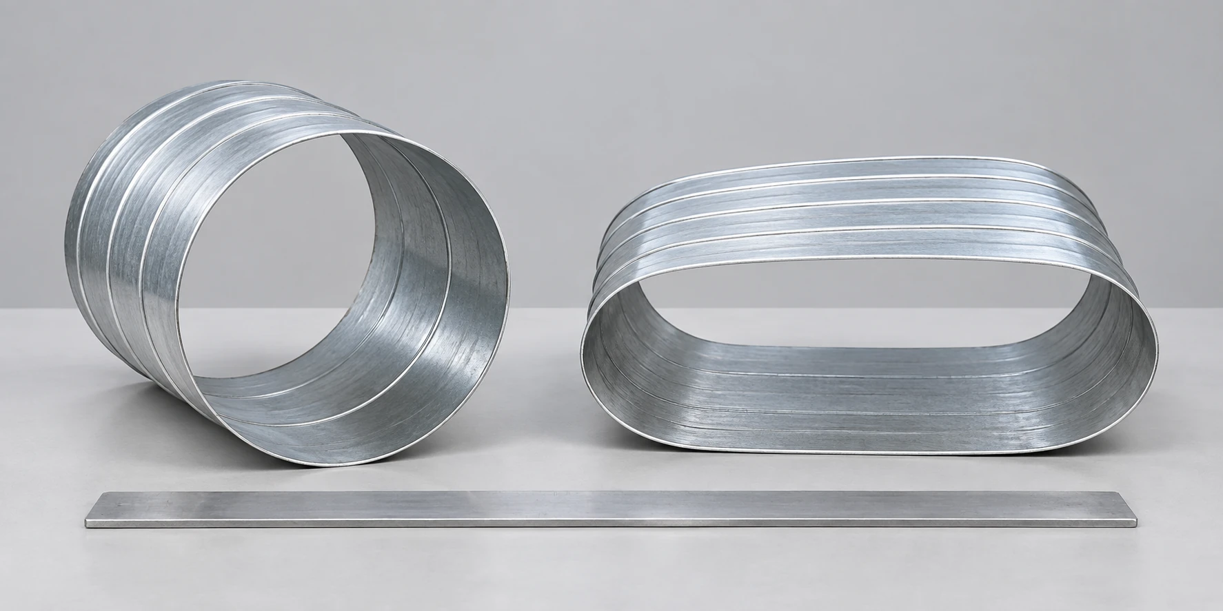 AI illustration of open round and flat-oval duct offcuts with a straightedge.